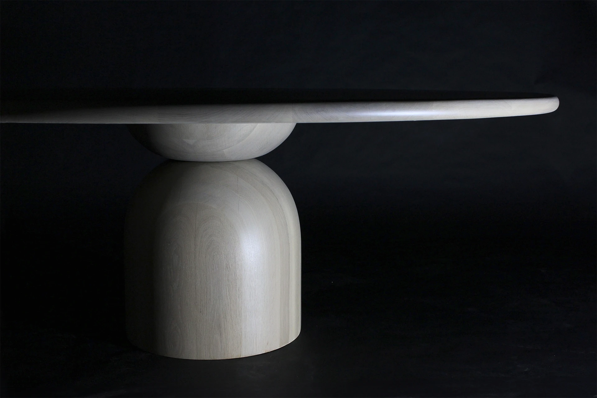 A wooden table with dark background