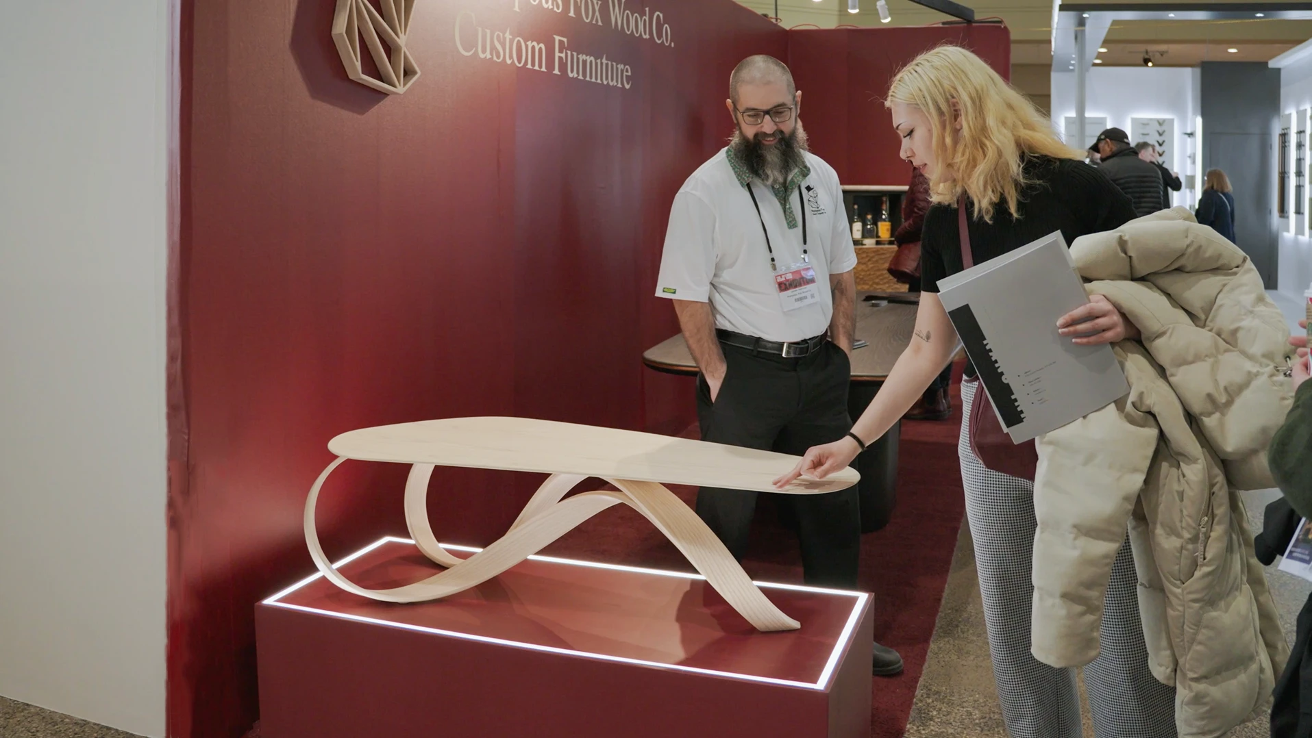 Visitor at the Interior Design Show Toronto admires the Pompous Fox Bent Wood Coffee table
